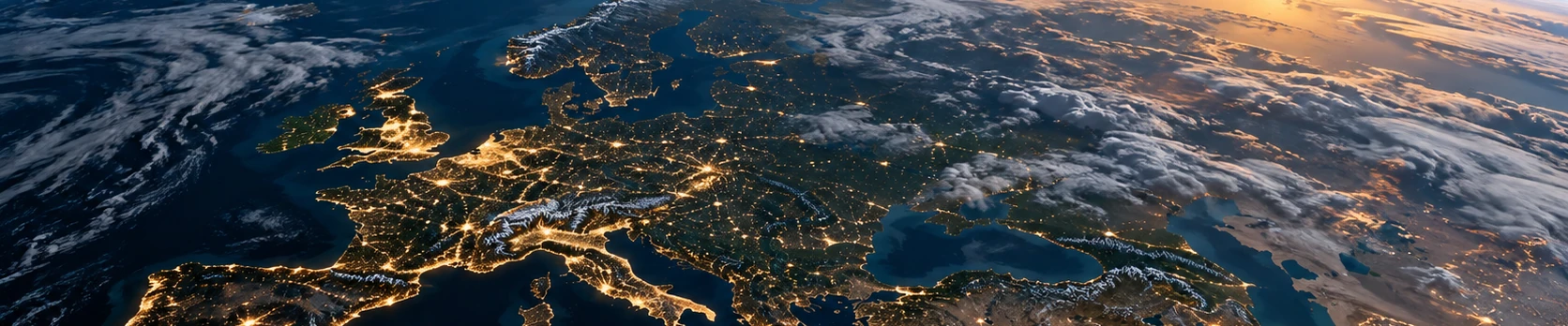 The Earth at night from orbit, a sunrise on the horizon